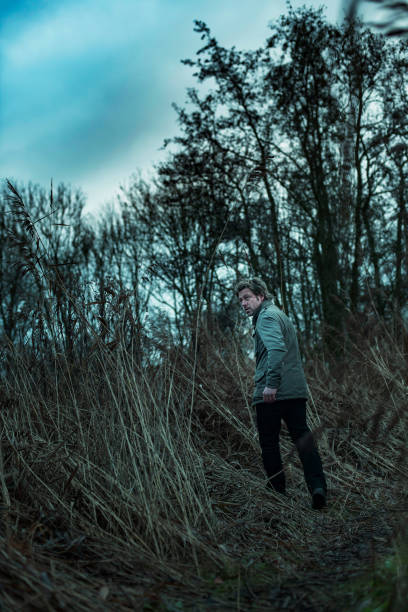 istock Man in jacket walking between reed in autumn. 1193258512
