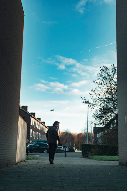 istock Man with handgun in residential area. 1193259155
