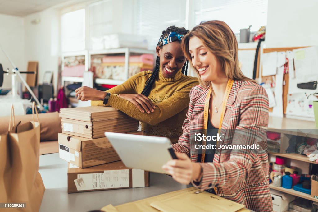 Sales Online. Working women at their store. Sales Online. Working women at their store. They accepting new orders online and packing merchandise for customer. Small Business Stock Photo