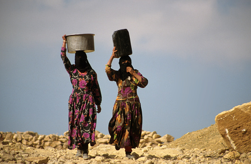 Yemen. Sa'dah'.December 05, 2010. Two young women are carrying water to the village in the countryside