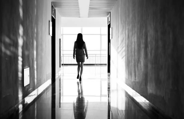 Businesswoman through the office corridor Businesswoman through the office corridor. people walking away stock pictures, royalty-free photos & images