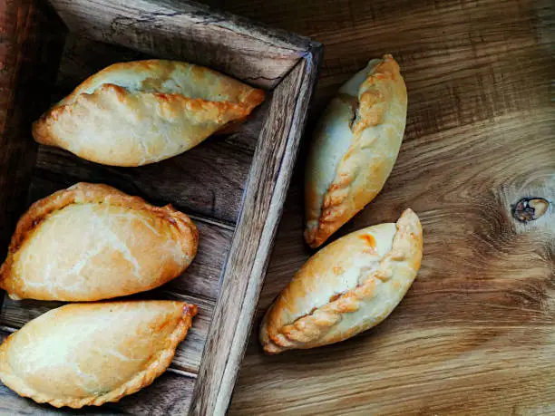 Photo of Bun with meat. Baguette with meat. Karaite Kibinai Lithuanian national dish.