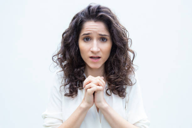istock Cute worried student girl keeping hands in pray gesture 1193260937
