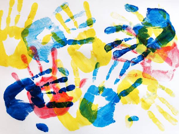 Autism awareness concept with colorful hands on white background. Top view.