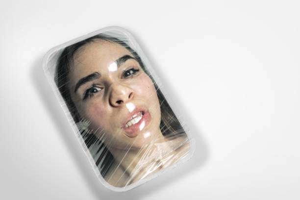 Human head as a goods in plastic box isolated on white background, ecology concept Cold. Human head as a goods in plastic box on white background, ecology concept. We're selling our organic future. Natural disaster, environmental problems, polymers pollution. Suffocating in garbage. woman strangles man stock pictures, royalty-free photos & images