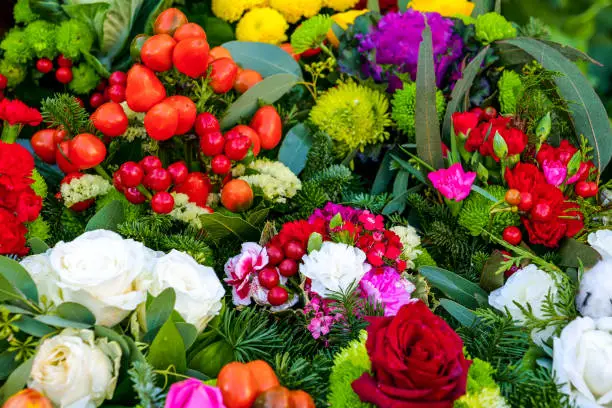 Photo of Some colorful bouquets decorated with roses, tulips, primroses, carnations and hollies