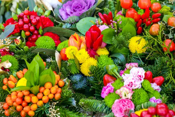Photo of Some colorful bouquets decorated with roses, tulips, primroses, carnations and hollies