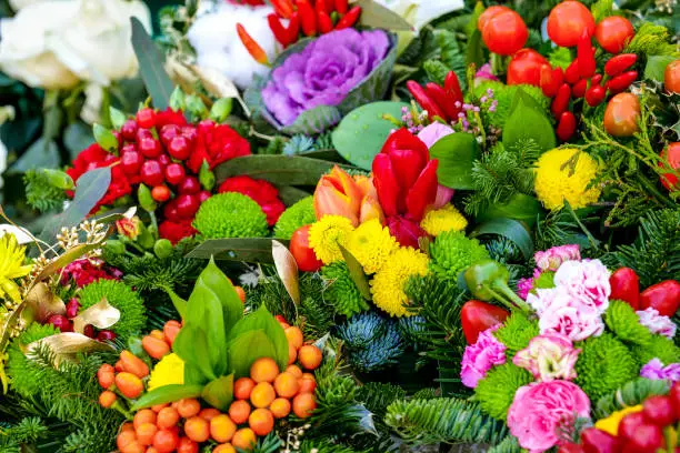 Photo of Some colorful bouquets decorated with roses, tulips, primroses, carnations and hollies