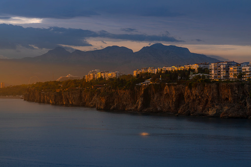 Sunset at Famous old city in Antalya with Konyaaltı beach and Bay mountains.