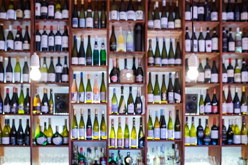 Germany: Defocused wine rack with different wine bottles.