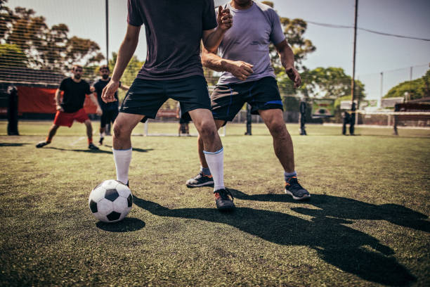 istock Men playing soccer outdoors 1193263766