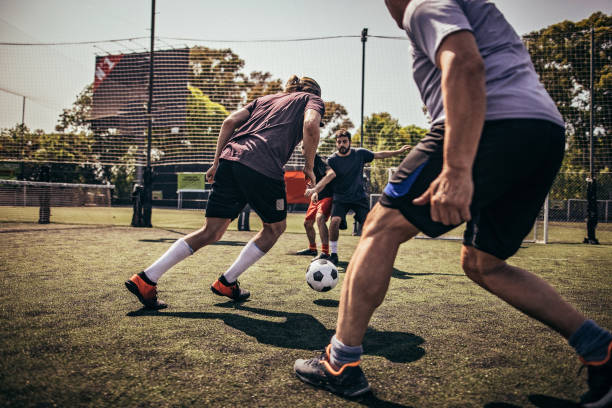 istock Men friends playing soccer 1193263853