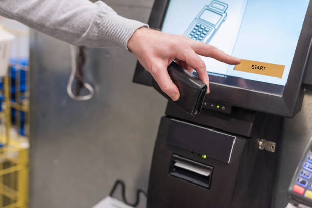 istock Man paying at the self-service counter using the touchscreen display and credit card. Isometric self-service cashier or terminal. 1193265158