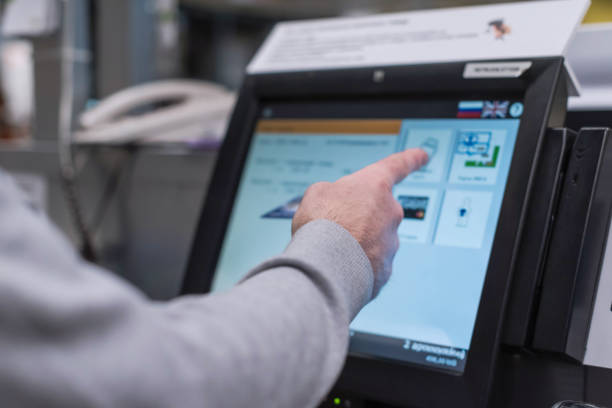 Man paying at the self-service counter using the touchscreen display and credit card. Isometric self-service cashier or terminal. Man paying at the self-service counter using the touchscreen display and credit card. Isometric self-service cashier or terminal. self checkout photos stock pictures, royalty-free photos & images