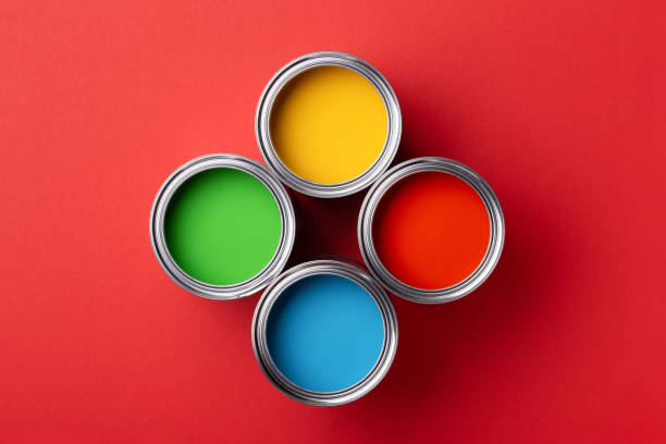 istock Cans of colorful paint on red background. 1193266935
