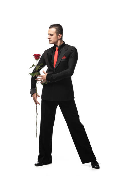 istock expressive dancer in elegant black suit performing tango with black rose on white background 1193267709