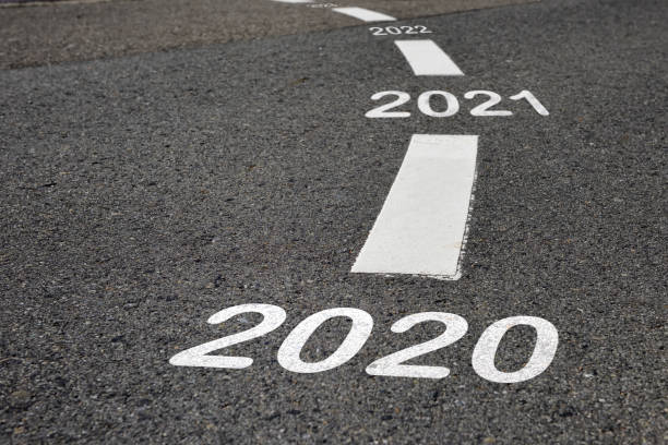 Happy new year 2020 to 2022 and road to success concept 2020 to 2022 on black asphalt road and white marking lines road warning sign photos stock pictures, royalty-free photos & images