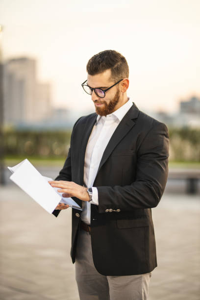 istock Businessman holding contracts 1193268707