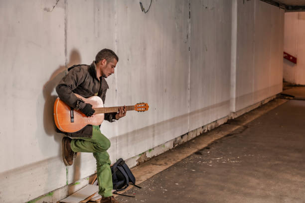 istock Street Performer with Guitar in the Subway 1193268741