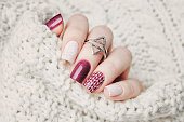 winter manicure against the backdrop of a warm knitted sweater