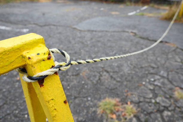 The rope and chain tied to the old iron rod