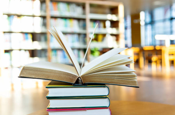 istock Stack of books on the table of public library 1193271413