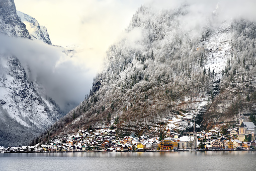 Winter scenic view of village of Hallstatt in the Austrian Alps from window of ship.