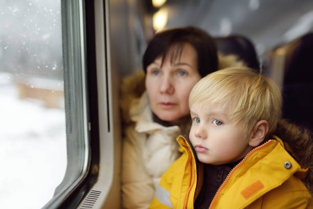 family looking out of the window of train during travel on cogwheel railway/rack railway in alps mountains. - rack railway imagens e fotografias de stock