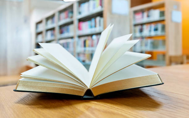 istock An open book on the table of public library 1193272412
