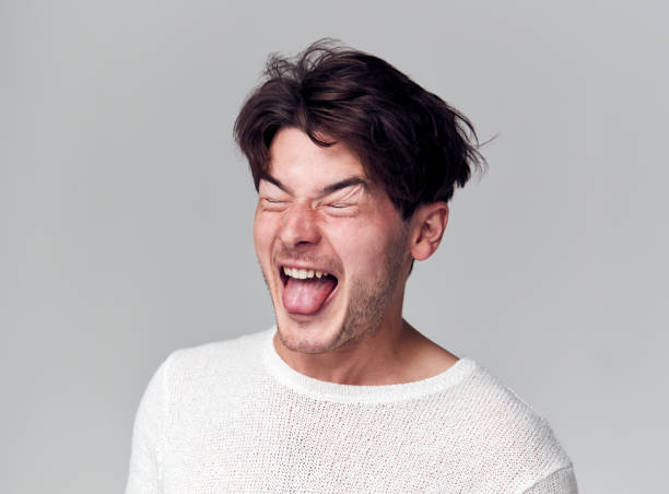 istock Head And Shoulders Studio Shot Of Man Pulling Faces And Smiling At Camera 1193273232