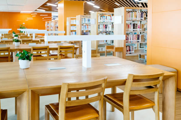 istock Empty wooden tables in public library 1193273394