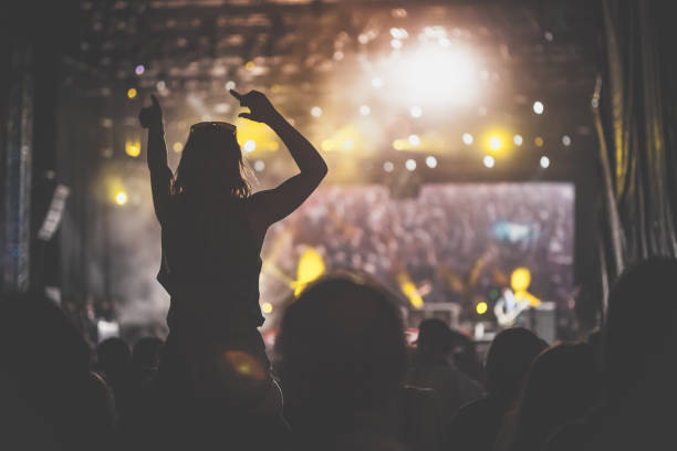 istock Large crowd dancing and cheering on a music concert 1193274685