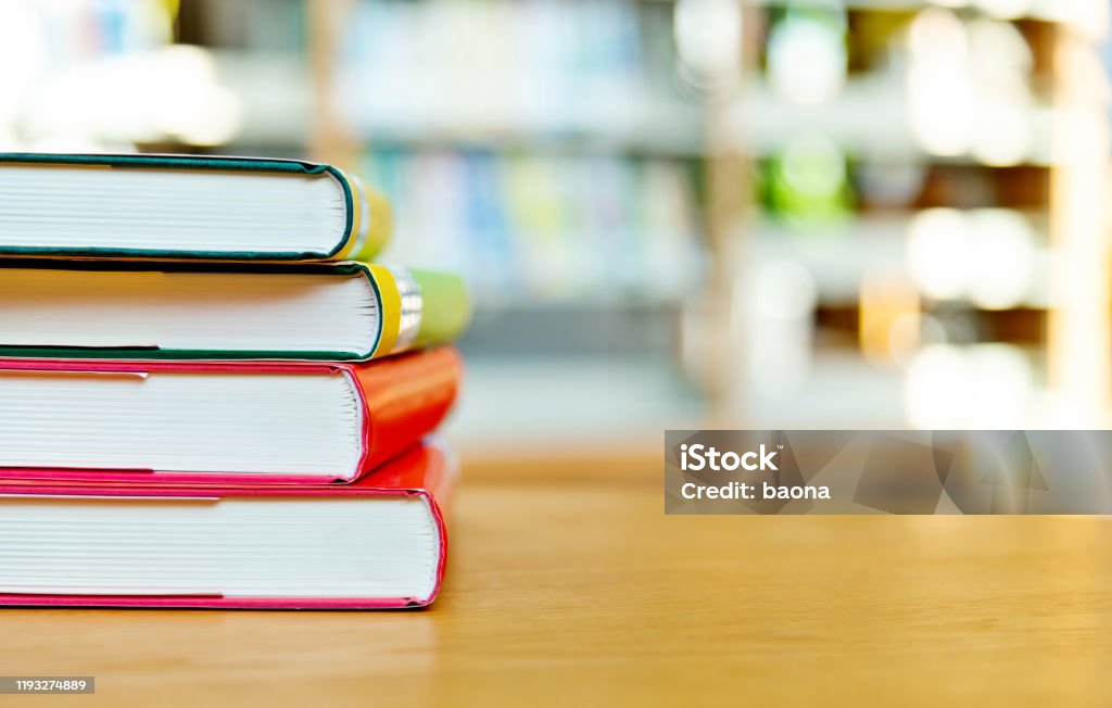 Stack of  books on the table of public library Stack of  books on the table of public library. Book Stock Photo