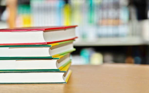 istock Stack of  books on the table of public library 1193275046