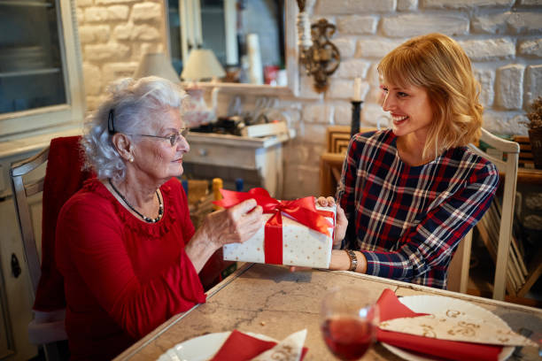 istock Caring daughter giving a Christmas gift 1193275136