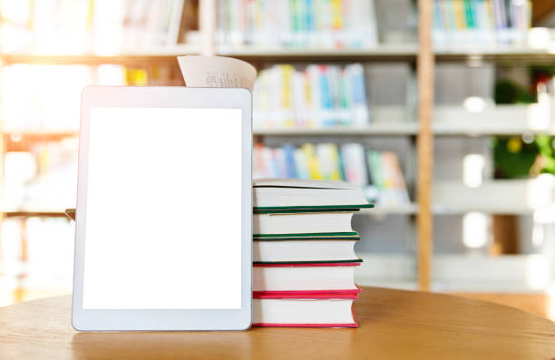 istock Digital tablet and books on the table of public library 1193275306