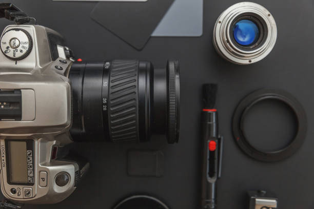 istock Photographer workplace with dslr camera system, camera cleaning kit, lens and camera accessory on dark black table background. Hobby travel photography concept Flat lay top view copy space 1193276203
