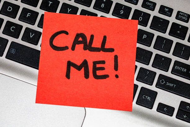 istock Writing on colorful sticky note Call me. Text with Call me on paper. Sticky note, post it on keyboard. 1193276608