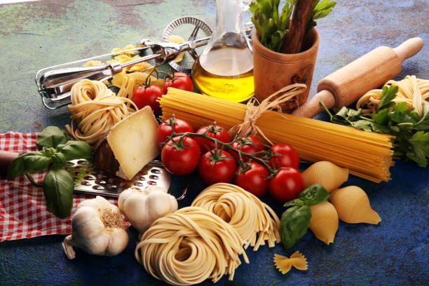 istock Pasta, vegetables, herbs and spices for Italian food on rustic table 1193276619