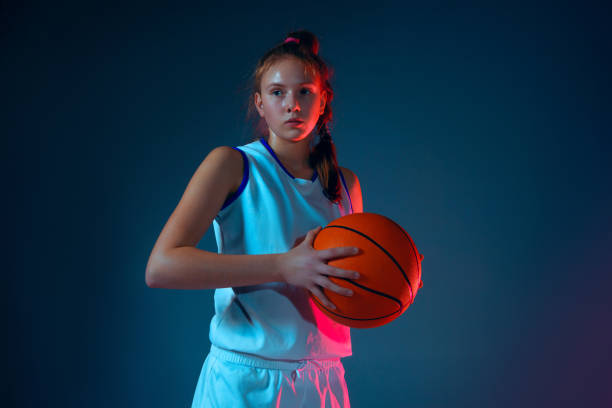 istock Young caucasian female basketball player on blue studio background in neon light 1193277687