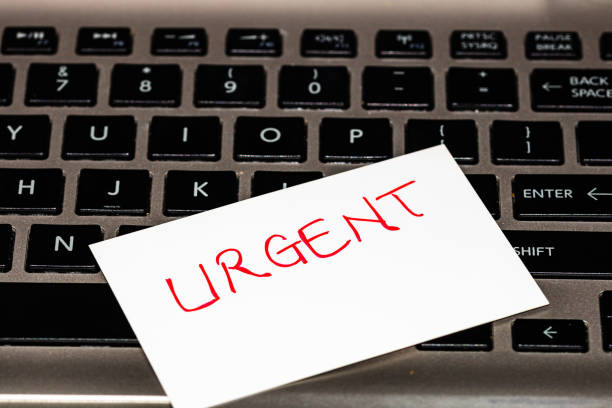 istock Writing on white label Urgent. Text with Urgent on a label on keyboard. 1193277874