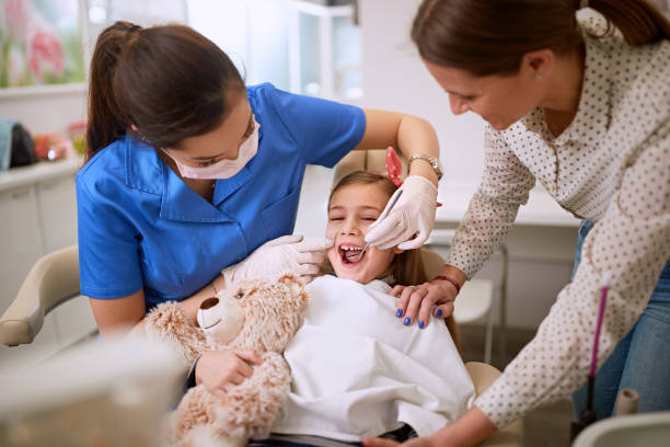 istock Dentist checking up girl’s teeth 1193277889