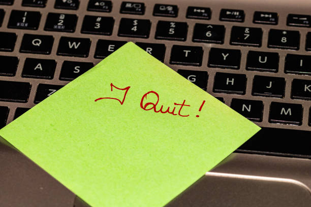istock Writing on colorful sticky note I quit. Text with I quit on paper. Sticky note, post it on keyboard. 1193278029