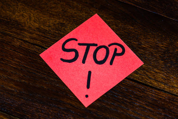 istock Writing on colorful sticky note STOP. Text with stop on paper. 1193278171
