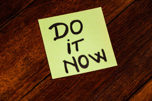 istock Writing on colorful sticky note do it now. Text with do it now on paper. 1193278229
