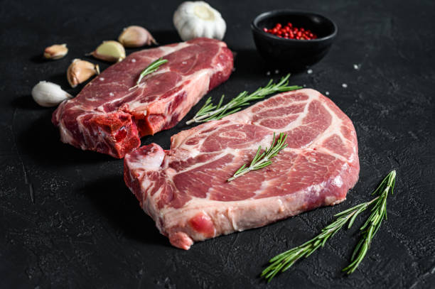 istock Fresh pork steak. Marbled meat. Black background. Top view 1193278378