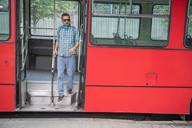 istock Young Man with Headphones is Exiting the Bus 1193278382
