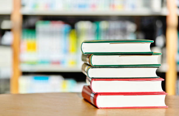 Stack of  books on the table of public library