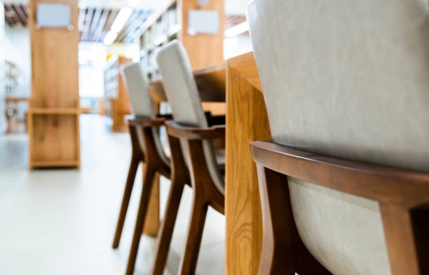 Chairs and bookshelves in modern library.