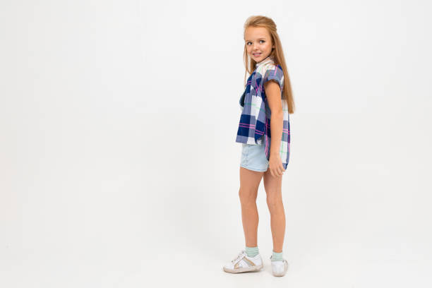 istock girl in a casual look stands sideways and poses on a white background with copy space 1193286708